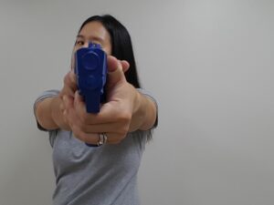 Pistol held with head turned to one side