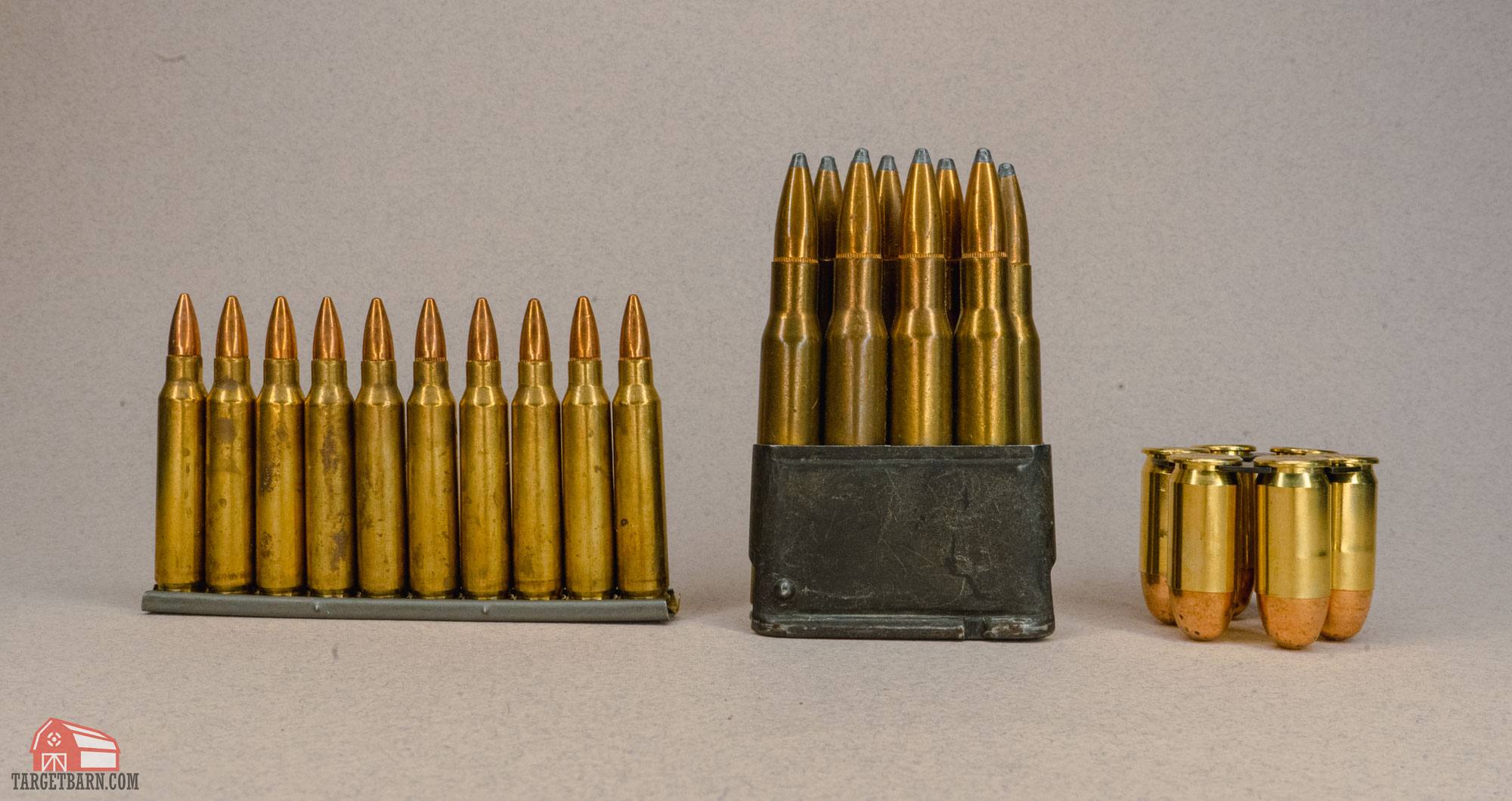a loaded stripper clip, en bloc clip, and moon clip seated next to each other