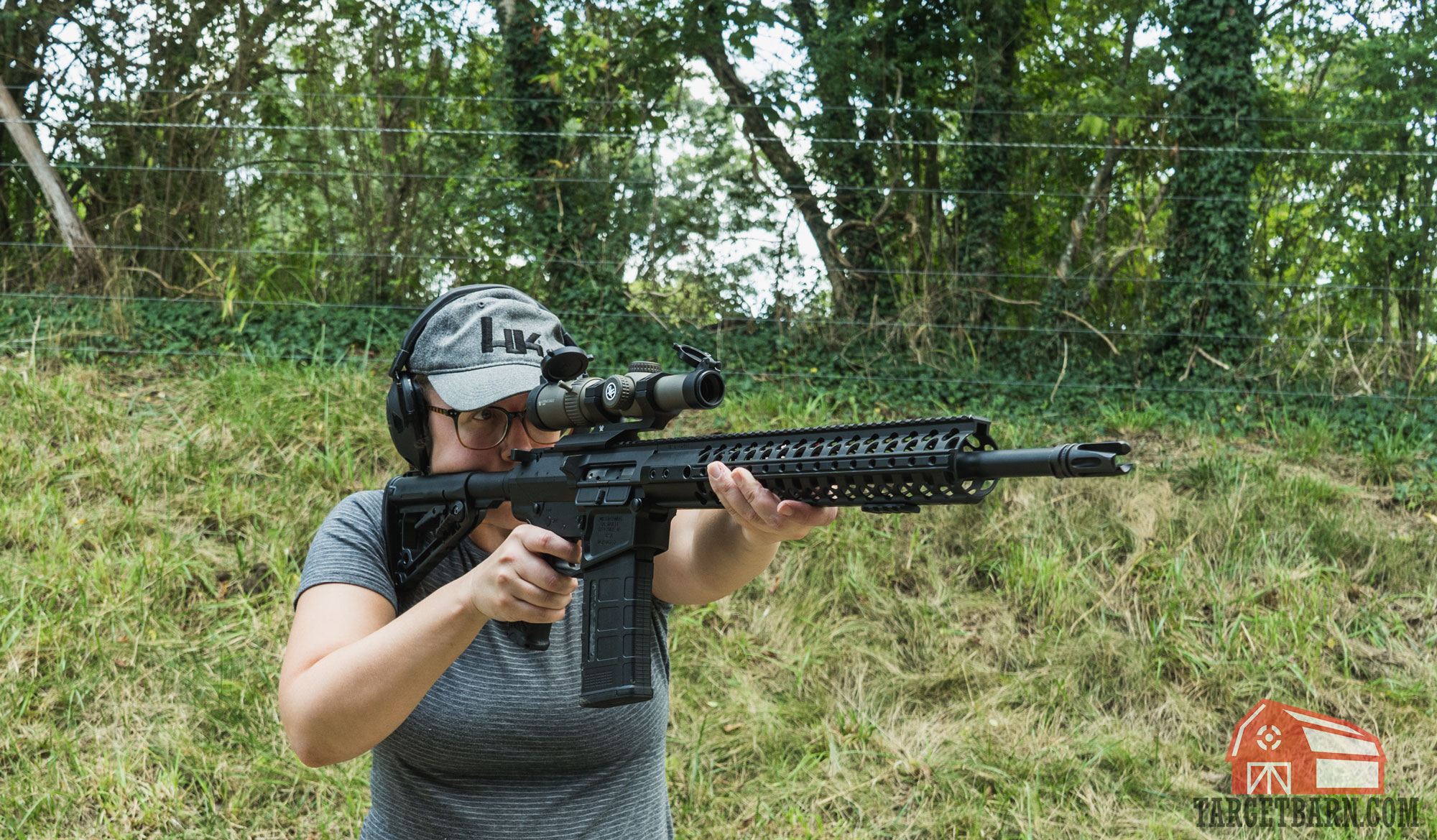 a woman shooting an ar-10 with a vortex strike eagle scope